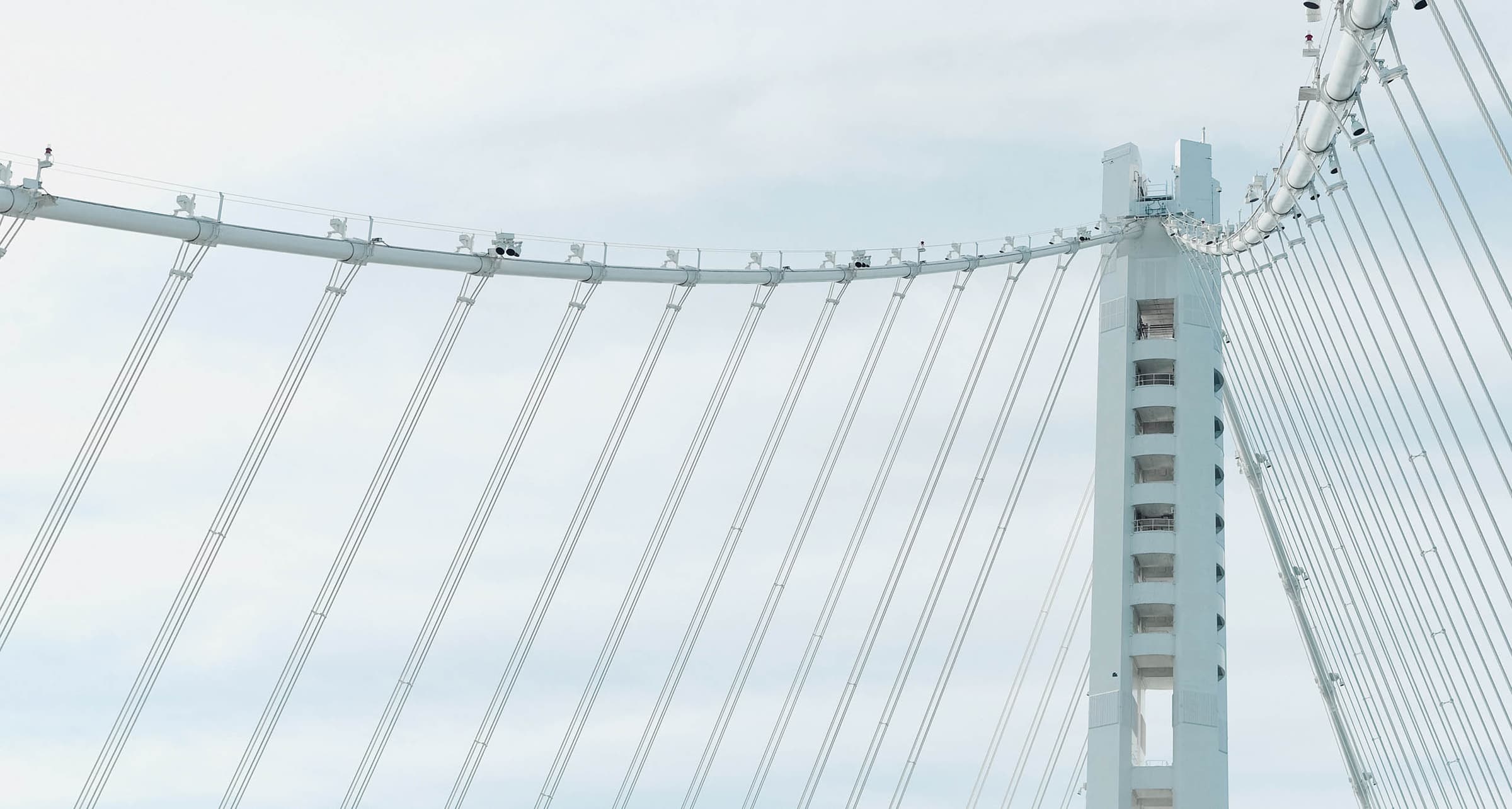 Suspension bridge cables against a clear sky