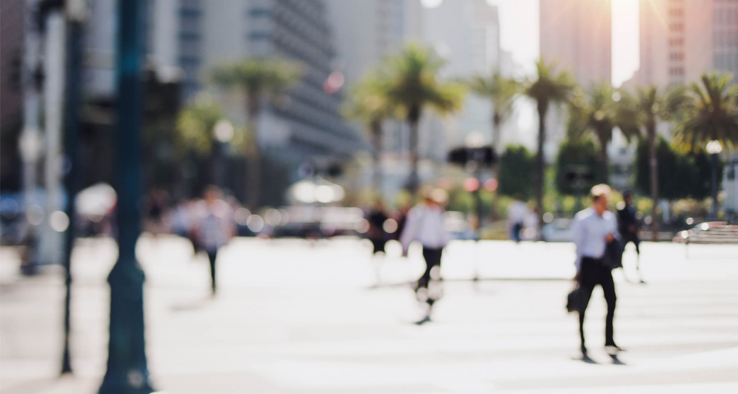 Professionals crossing a busy downtown plaza