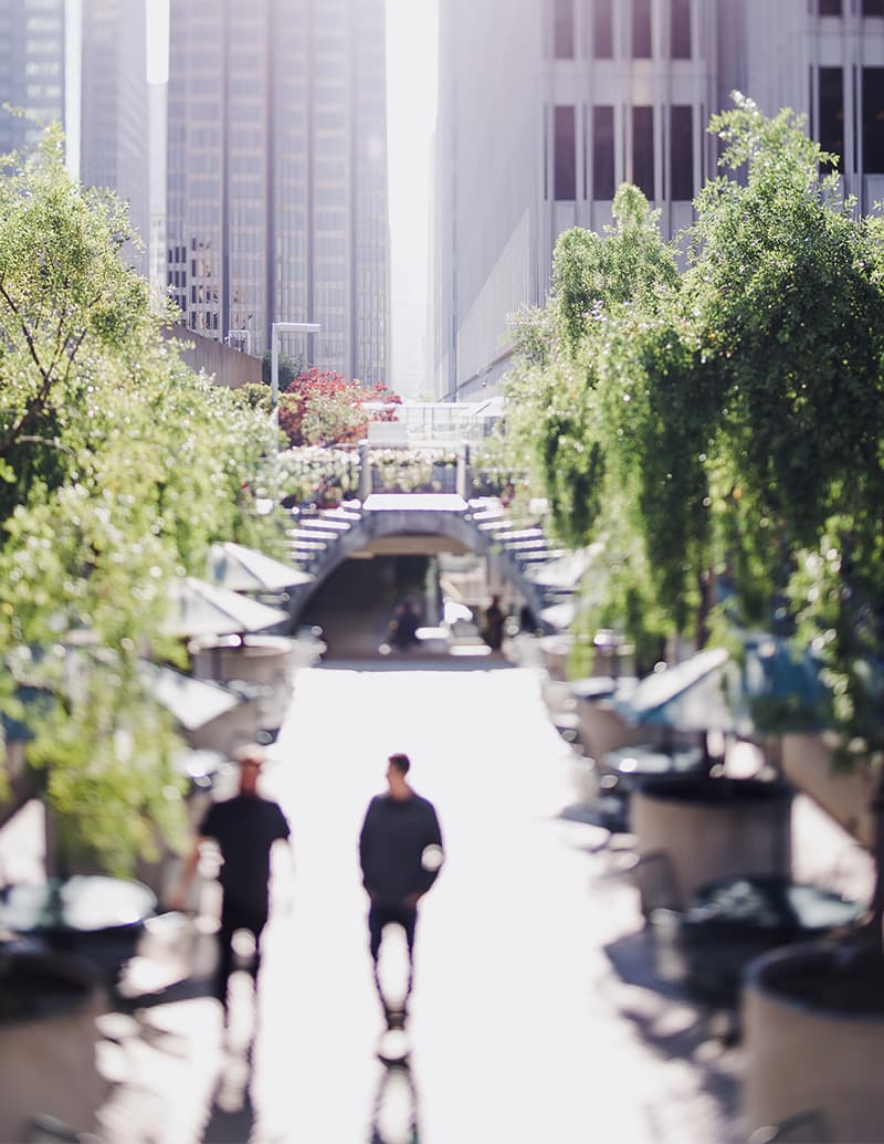 Professionals walking through a city plaza